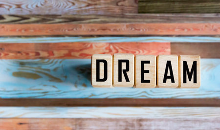 The word Dream written on wooden blocks and vintage backgroundの写真素材