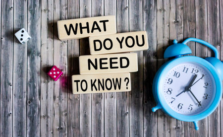 Wooden blocks with the inscription What you need to know on a vintage background with a clock.の写真素材
