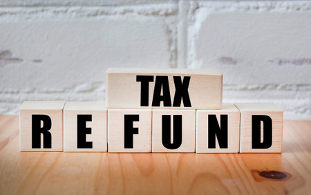 Tax refund - payment to taxpayer when taxpayer pays more tax than he owes on wooden blocksの写真素材