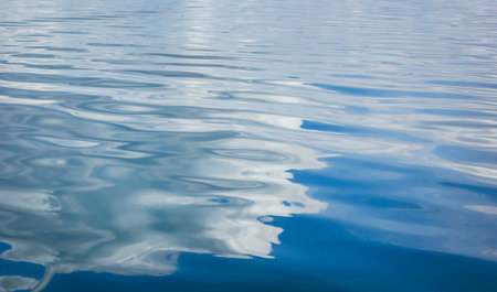 Blue water with ripples on the surface. Defocus blurred transparent surface texture of calm blue...
