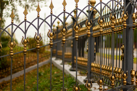 Metal fence in the city park. Decorative black iron guardrail for protection, close upの写真素材