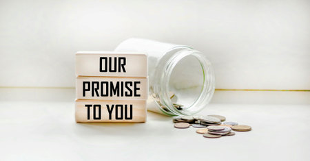 Wooden blocks with the superimposed text OUR PROMISE TO YOU. The concept of tax and financial...
