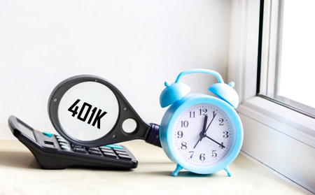 The 401k word, written on a magnifying glass that lies on the calculator next to the watch, is a...