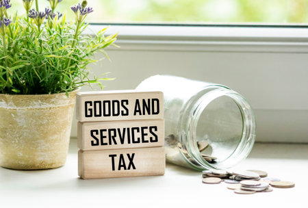 Goods, services, and taxes. GST lettering on wooden blocks and beautiful background