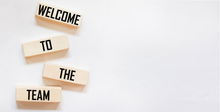 Welcome to the symbol of our team. Concept words Welcome to our team on wooden blocks. Beautiful background. Copy space.の写真素材