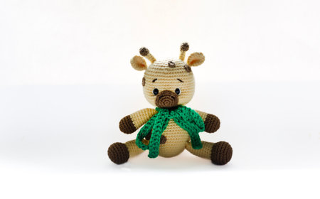 Handmade knitted toy with beige body and brown spots. Perfect for crafts, children's toys and unique gifts.の写真素材