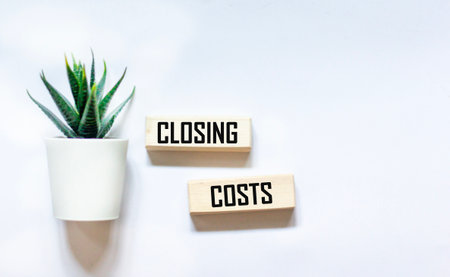 CLOSING COSTS - words on wooden blocks on a white background