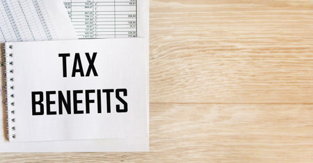 There is an inscription on the notebook TAX BENEFITS against the background of accounting.の写真素材