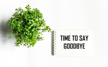 It's time to say goodbye text on a notepad on a white background