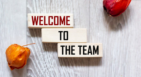 Welcome to the team. Text on wooden blocks on a gray backgroundの写真素材