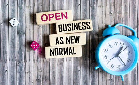 Wooden blocks with words 'OPEN BUSINESS AS NEW NORMAL'.の写真素材