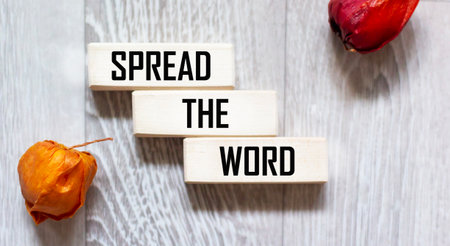 The concept of a communication network for word-of-mouth advertising distribution. SPREAD THE INFORMATION text on wooden blocksの写真素材
