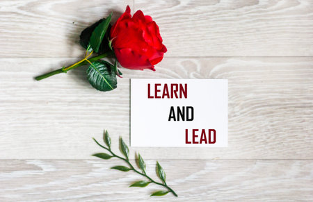 The words Learn and Lead are written on a sticker on a light background.