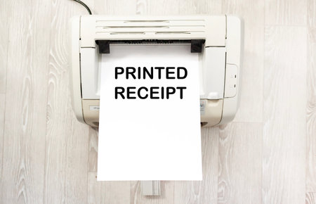 A printer with paper on the printed text Printed Receipt on it