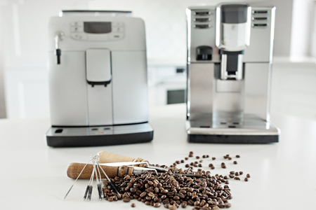 Tools for repairing coffee machines close-up. Coffee beans, wooden board, coffee machine, kitchen tableの写真素材