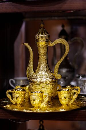 Arabian cup and teapot of gold on the eastern market. Oriental teaの写真素材