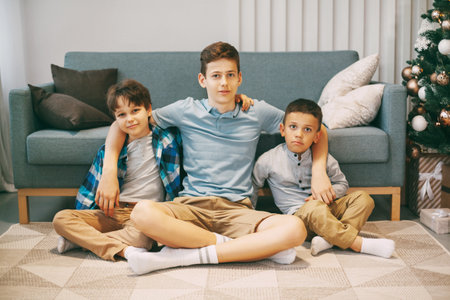 Three teenage brothers play and frolic at home on weekends. Friends spend the weekend together. Family, friendship, relationships.の写真素材