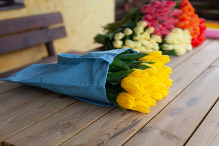 Bouquet of multi-colored tulips on a wooden background. View from above. Valentines Day, Womens Day, Mothers Dayの写真素材