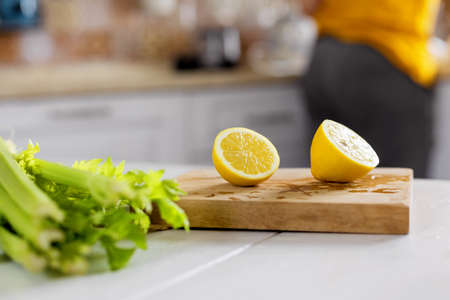 Fresh organic vegetables and lemons are on the table in the kitchenの写真素材
