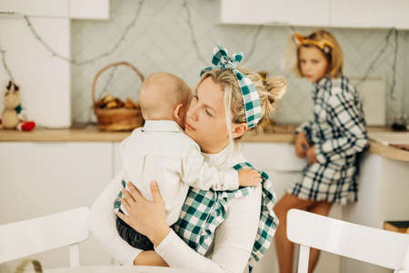 Happy family mother and children son and daughter bake cookies for Christmas. Christmas spirit, a family traditionの写真素材