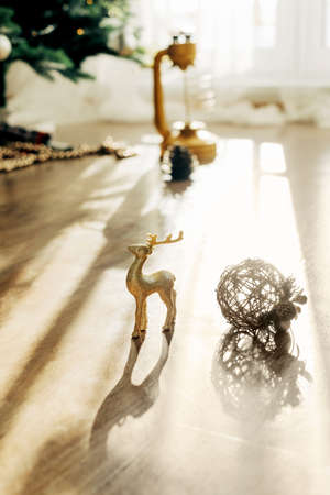 Golden deer and Christmas ball on the background of the Christmas tree, details of decorations. Christmas still life, winter compositionの写真素材