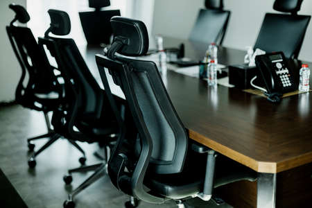 Empty conference room with black chairs and wooden tableの写真素材