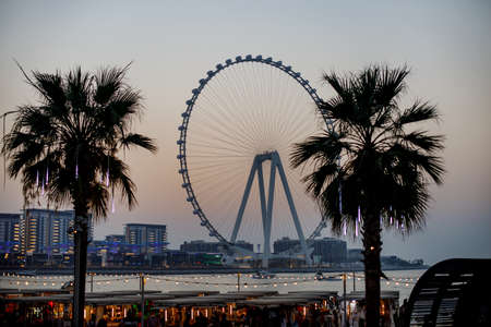 Dubai, UAE, May 2021. Sunset over the island of Blue Waters with the famous Dubai Eye Ferris wheelのeditorial素材