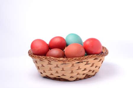 Easter eggs in basket. White background.の写真素材