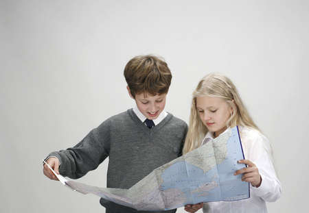 boy and girl with map of roadsの写真素材