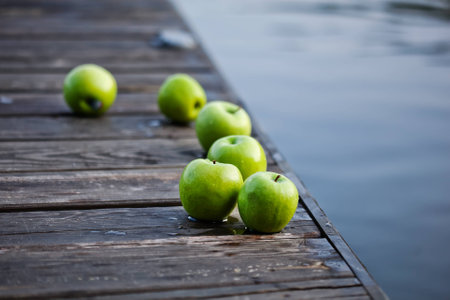 fresh green apples on wooden surfaceの写真素材