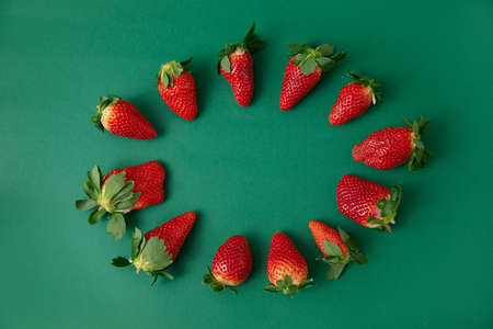 red Strawberries on the green backgroundの写真素材