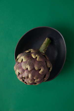 Fresh Artichoke on the green backgroundの写真素材