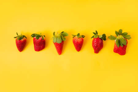 red Strawberries on the yellow backgroundの写真素材