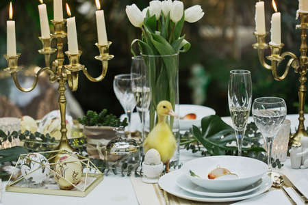 beautiful and cozy bright easter table decorationの写真素材
