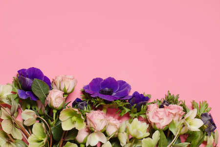 bouquet of multicolored different flowers on the pink background. Copy text for a menu, reception, party poster, or wedding invitation.の写真素材