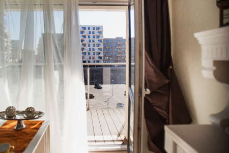 Interior of a hotel room with a large window overlooking the city