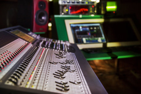 Audio mixing console in a recording studio. Selective focus. Shallow depth of field