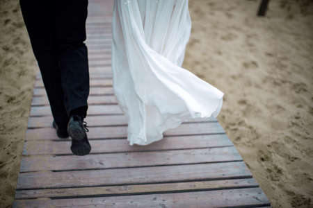 Wedding couple on the beach. Bride and groom on the pier