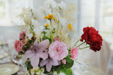 Flower arrangement on the table at a wedding ceremony. Wedding decor