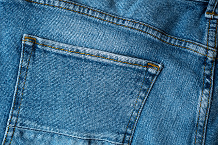 Backside denim blue jeans with pocket for background. Premium quality fabric with perfect seams.の写真素材
