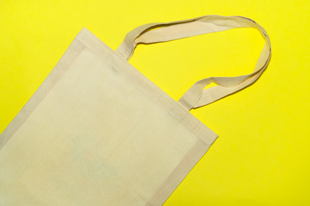 Ecofriendly bag on bright yellow background. Zero waste concept.