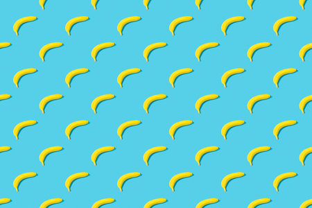 Seamless pattern with yellow ripe bananas on blue background. Fruit abstract seamless pattern.