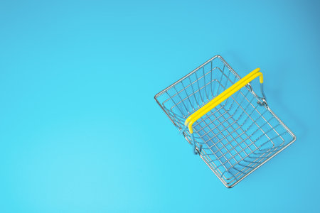 Shopping basket on blue background with copy space. Shopping concept.