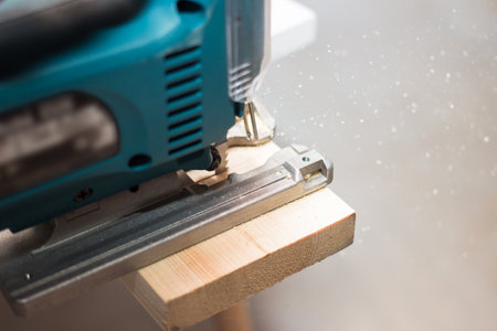 Power tool. Image of electric fretsaw in action. Machine saw with a fine blade.