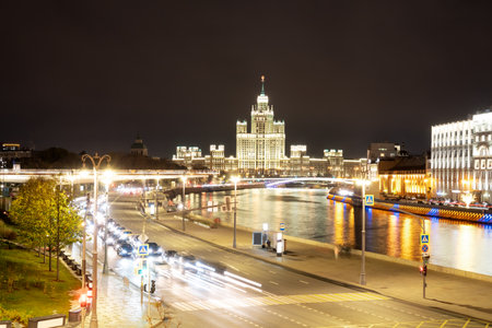 Night landscape of the center of Moscow with a view of the high-rise on the Kotelnicheskaya embankment, the Floating bridge of Zaryadye Park and the Moscow river. City in night illumination.の写真素材