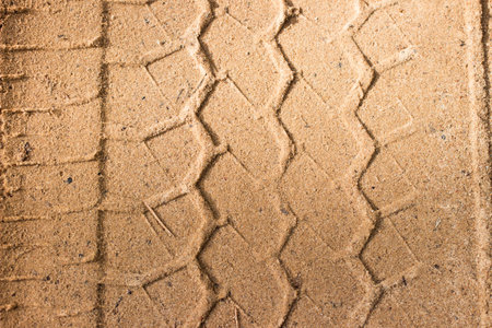 Car wheel imprint on a sandy road. Forest road from sand in the countryside.の写真素材