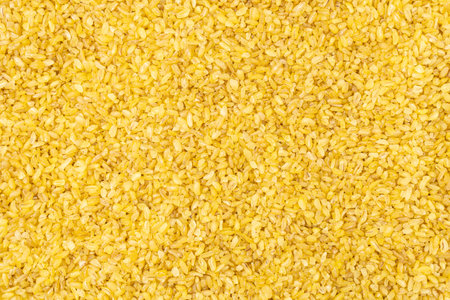 Bulgur grains of durum wheat textured background.の写真素材
