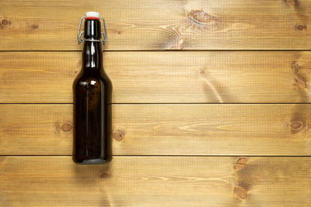 Bottle of craft beer on wooden table with copy space.の写真素材