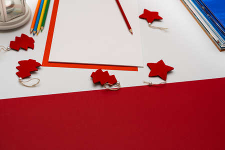 Blank sheet of white paper for writing a letter to Santa Clause or wish on red and white combined...