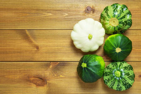 Pattypan squashes on wooden table background. Fresh dieting vegetables.の写真素材